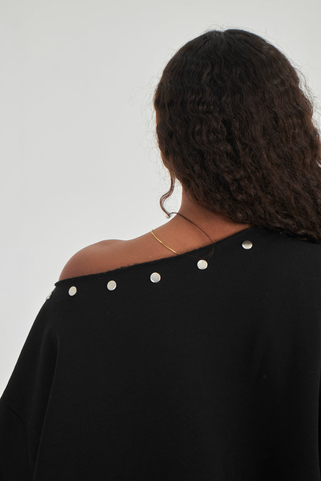 Studded black off-shoulder sweater